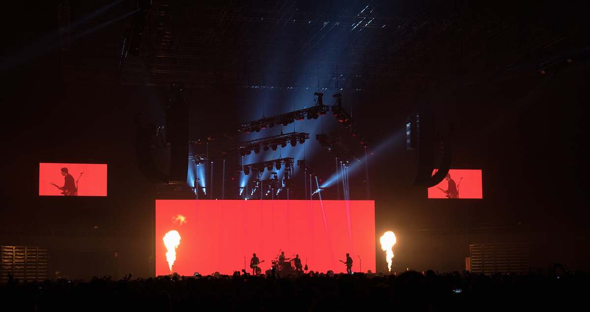 birmingham band performing on stage in front of crown during nighttime united kingdom